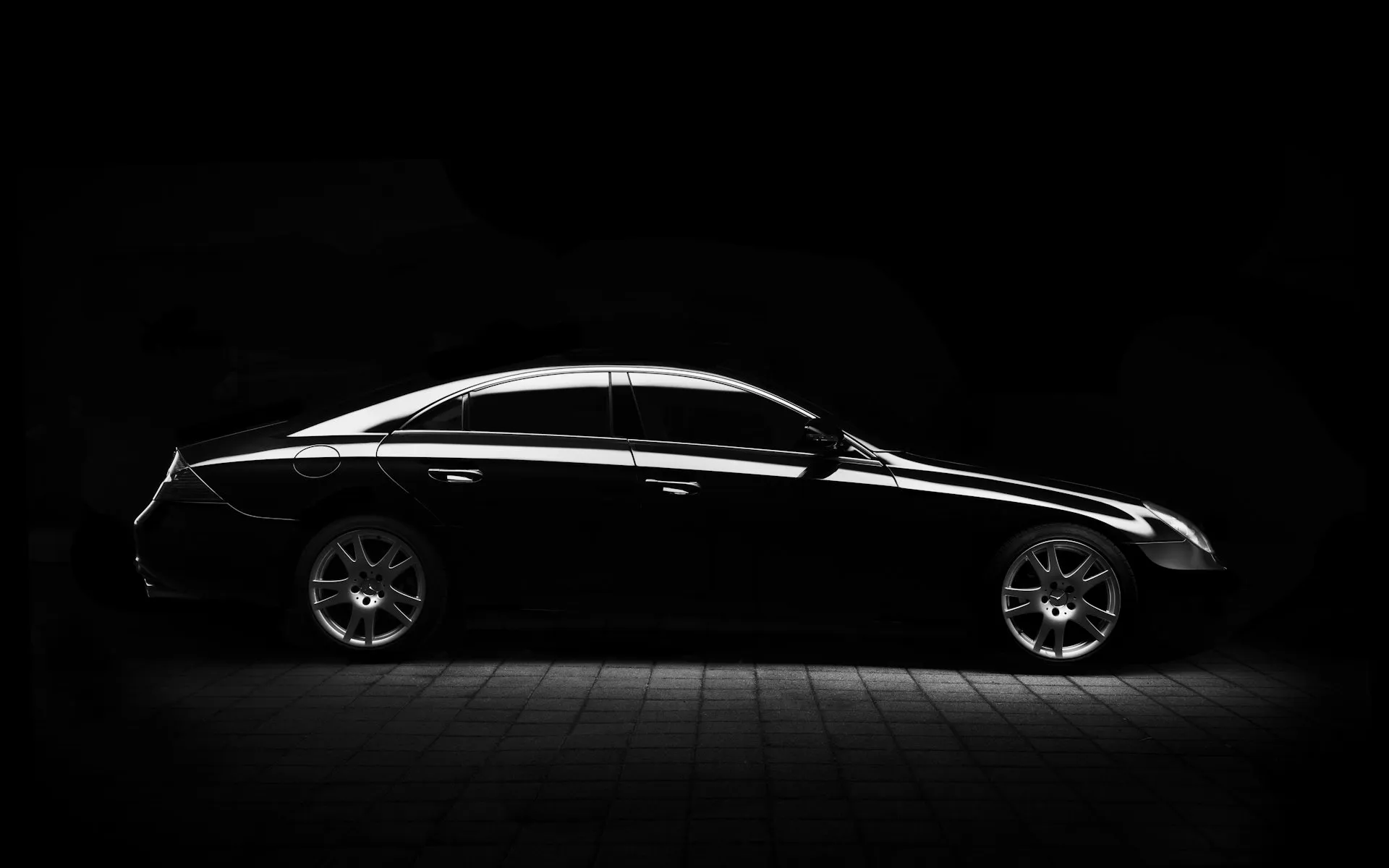 Luxury car on an open road at dusk, inviting a premium Malaysia driving experience