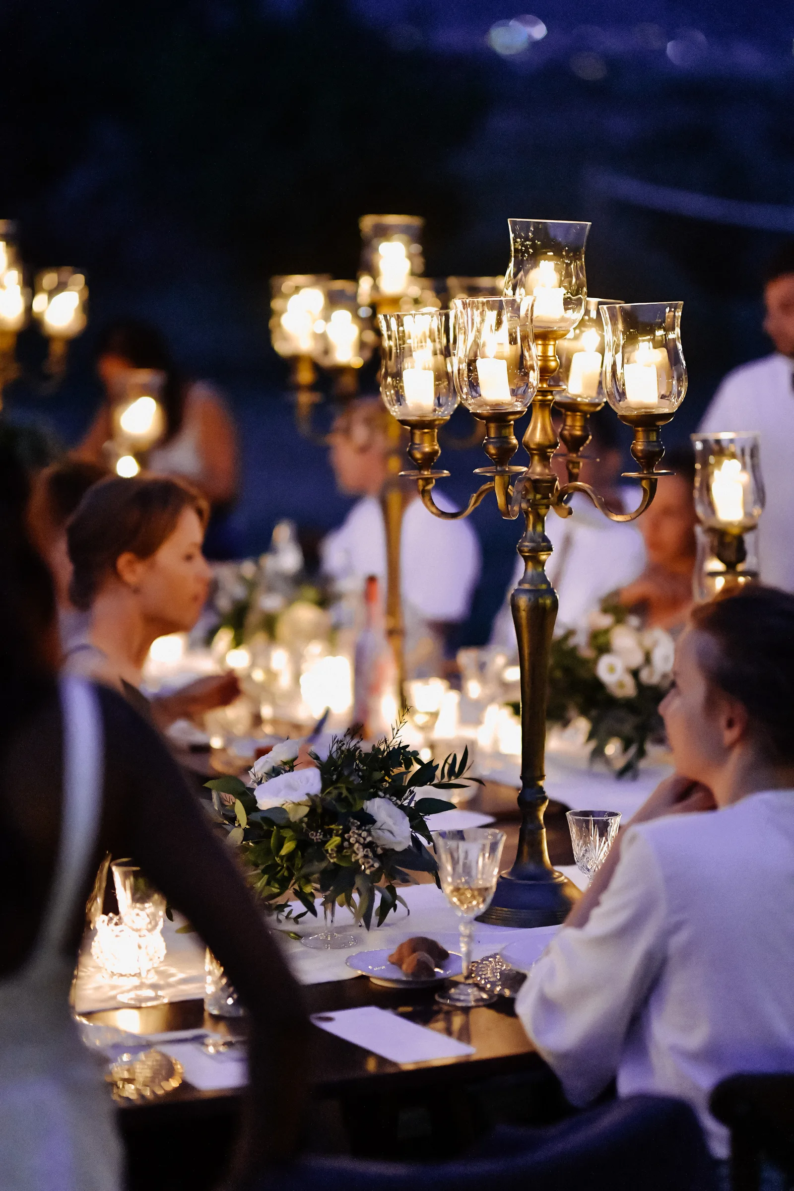 Candlelit outdoor dinner table prepared for a special event